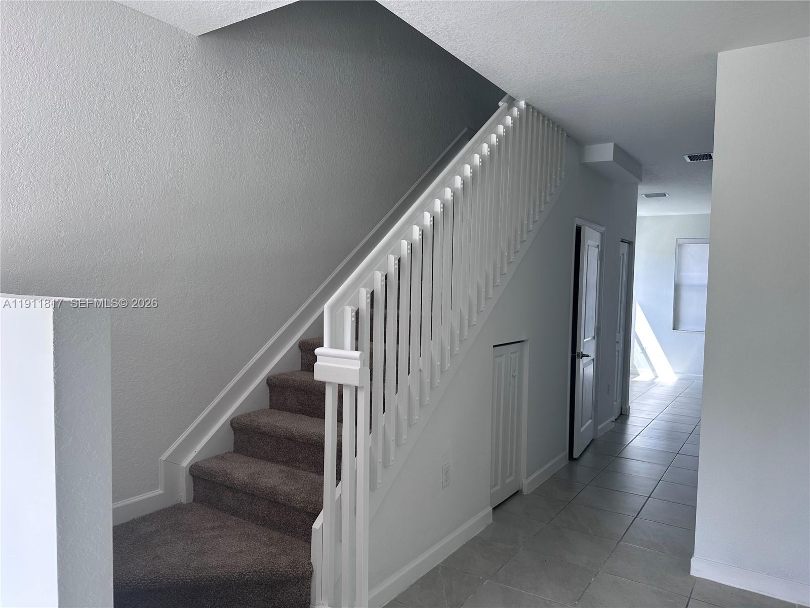 1884 Southeast 27th Street Homestead, FL 33035 - Photo 16 of 34 a view of hallway with stairs