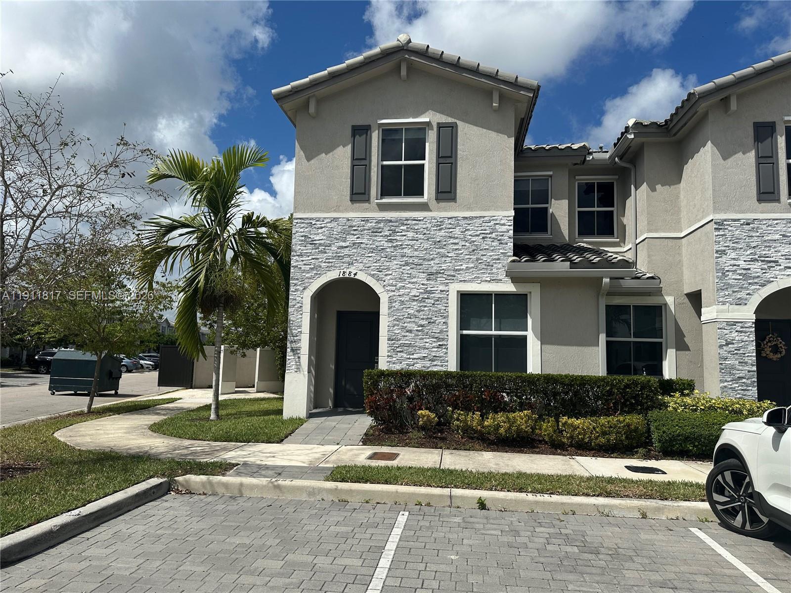 1884 Southeast 27th Street Homestead, FL 33035 - Photo 2 of 34 a front view of a house with a yard
