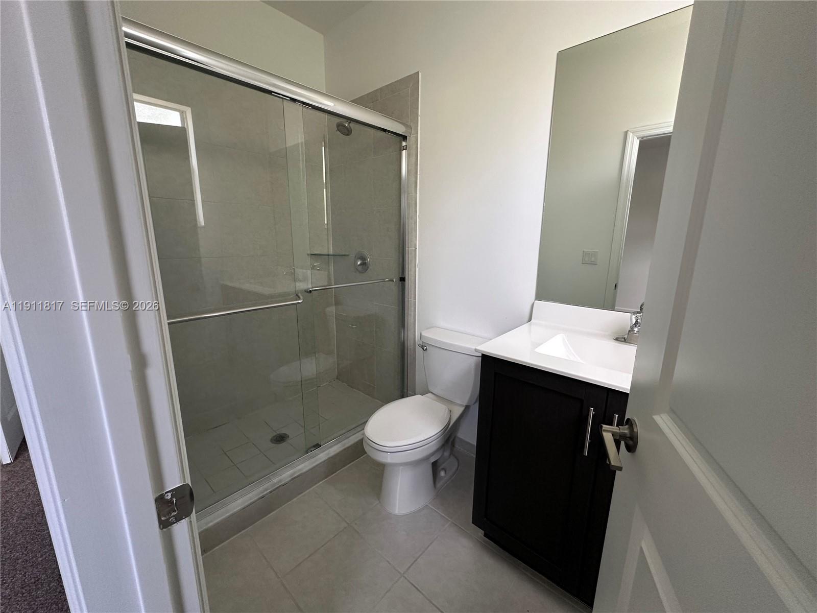 1884 Southeast 27th Street Homestead, FL 33035 - Photo 26 of 34 a bathroom with a toilet and a shower
