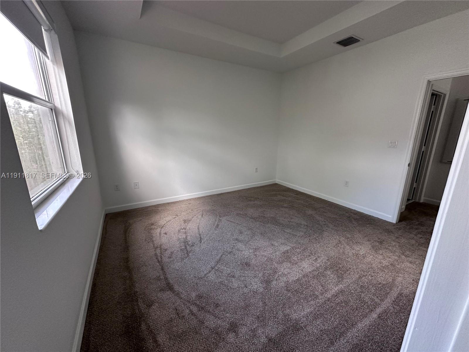 1884 Southeast 27th Street Homestead, FL 33035 - Photo 28 of 34 an empty room with windows