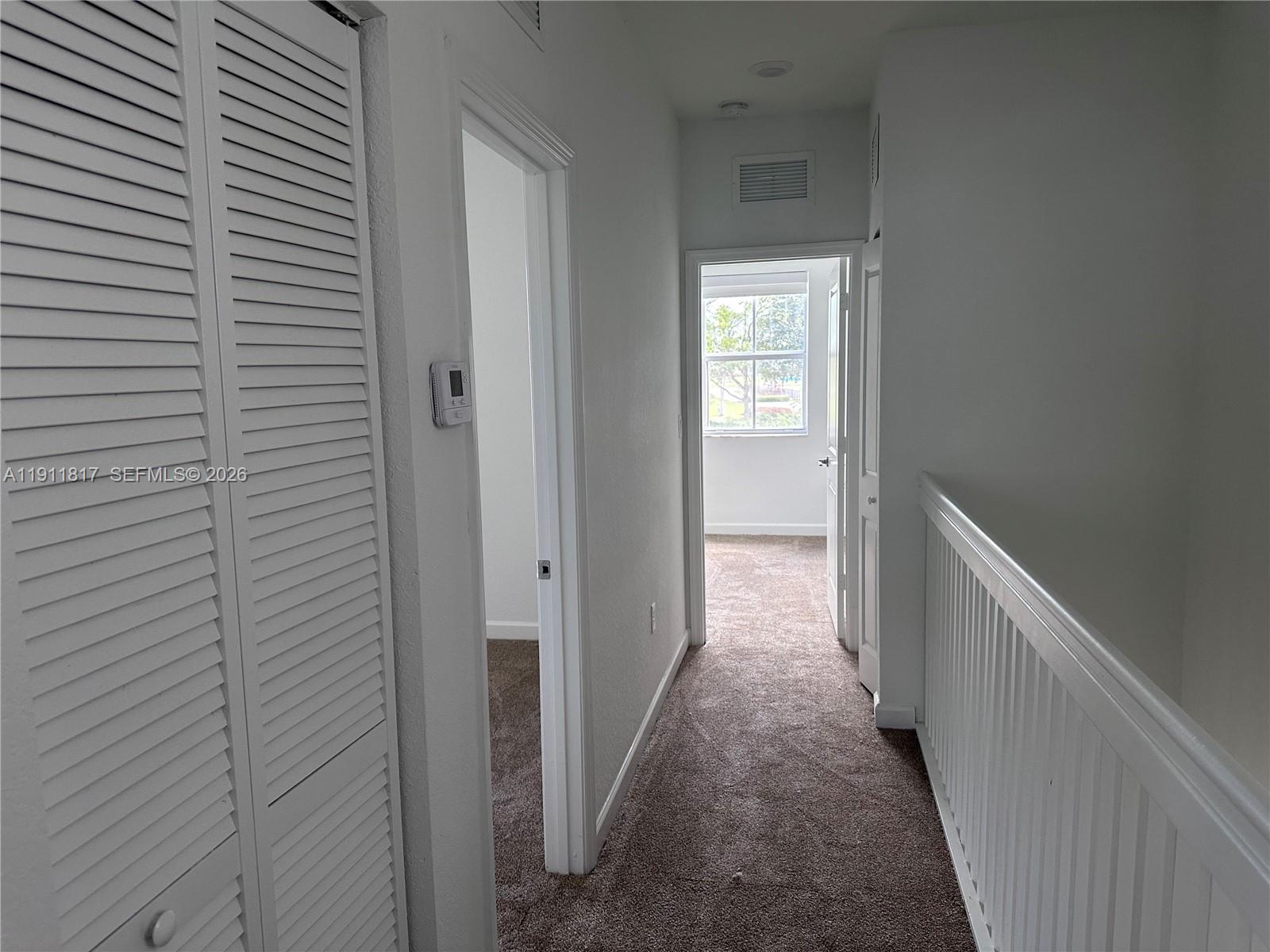 1884 Southeast 27th Street Homestead, FL 33035 - Photo 30 of 34 a view of a hallway with a white door