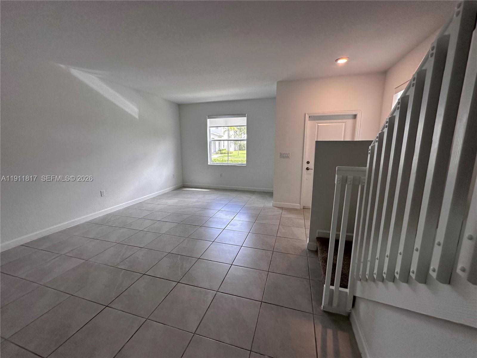 1884 Southeast 27th Street Homestead, FL 33035 - Photo 5 of 34 a view of a livingroom with an empty space and a window