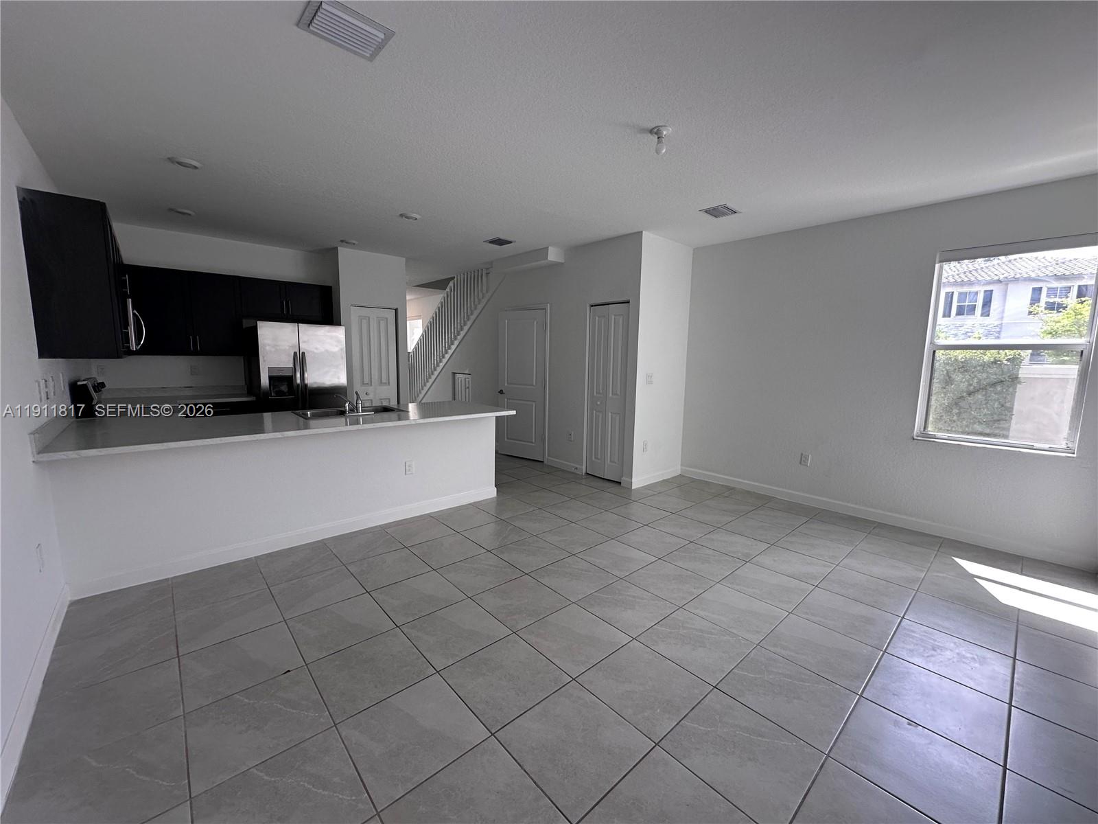 1884 Southeast 27th Street Homestead, FL 33035 - Photo 6 of 34 a view of a kitchen with a sink and a microwave