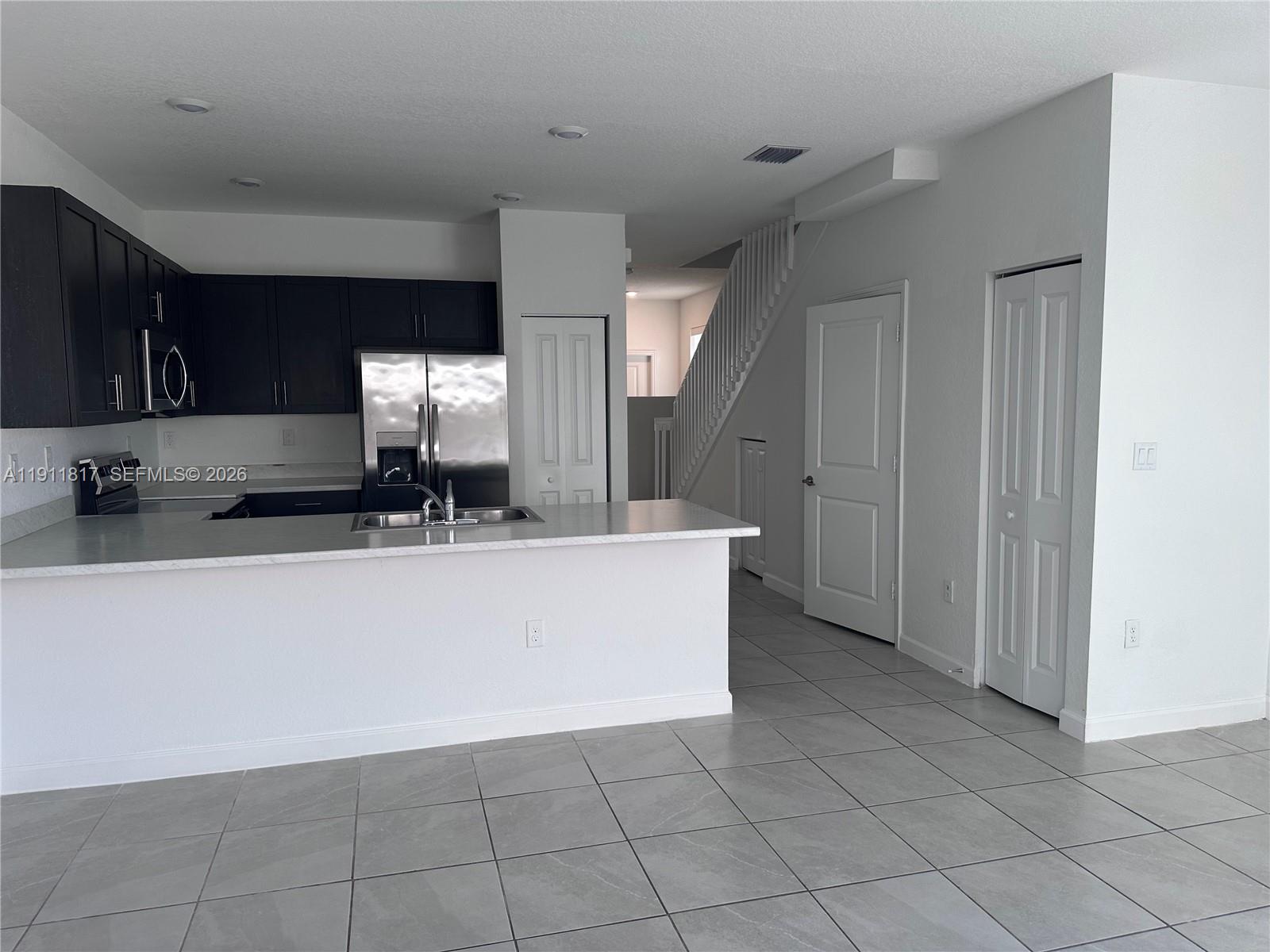 1884 Southeast 27th Street Homestead, FL 33035 - Photo 10 of 34 a view of a kitchen with cabinets