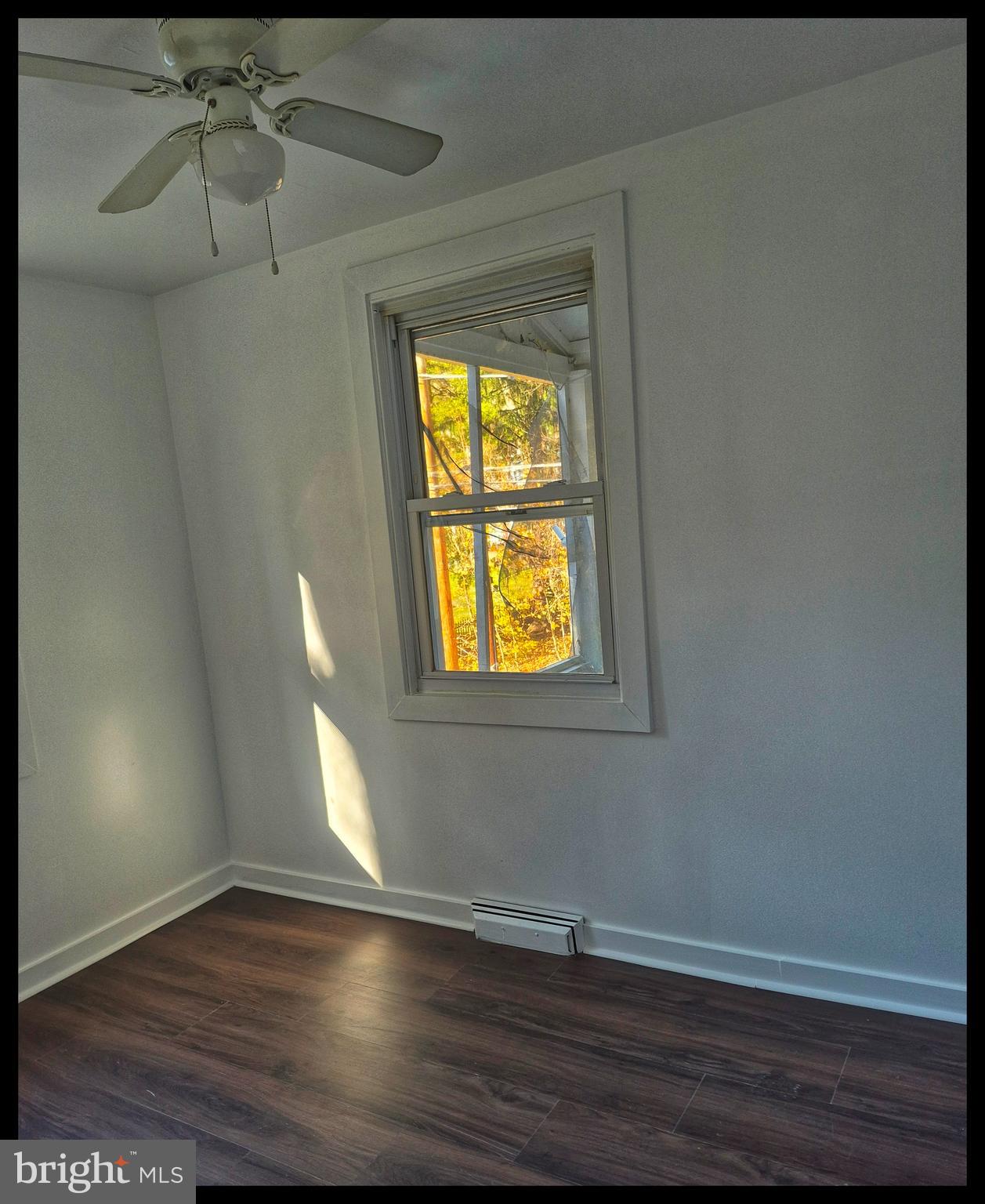 112 Chesterville Road Landenberg, PA 19350 - Photo 2 of 2 a view of an empty room with wooden floor and a window