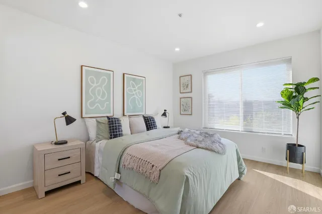 a bedroom with bed and a window