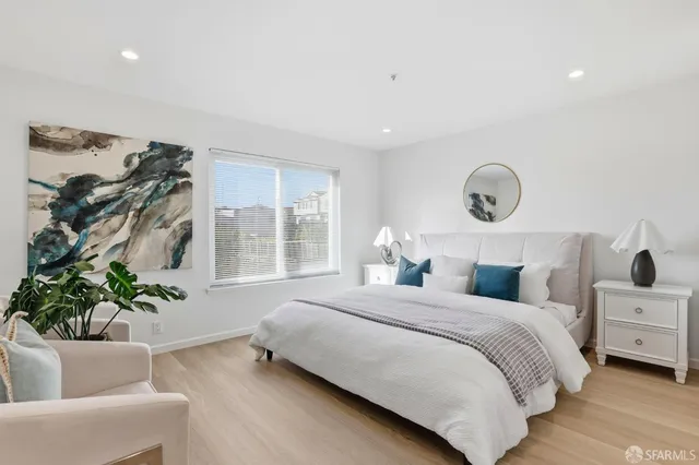 a bedroom with bed and a potted plant