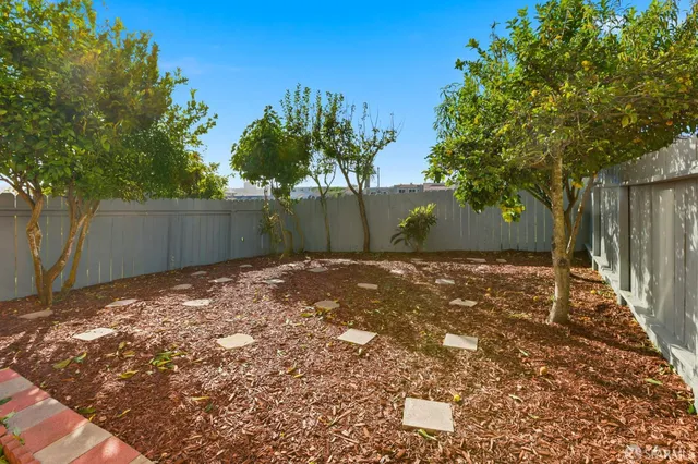 a backyard of a house with large trees