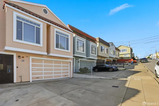 a front view of a house with a parking space