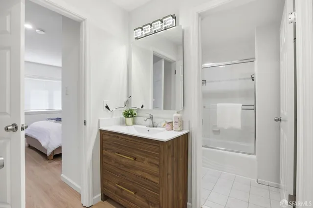 a en suite bathroom with a sink a mirror and a shower