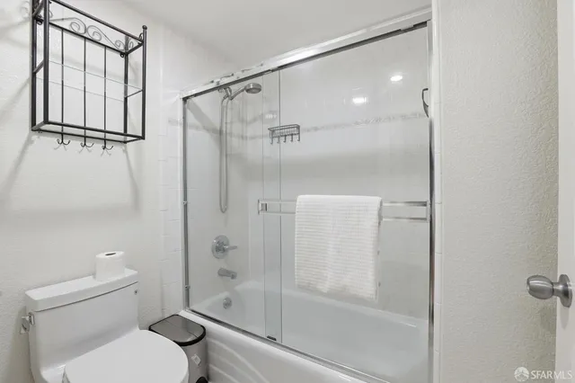 a bathroom with a shower a toilet and a shower