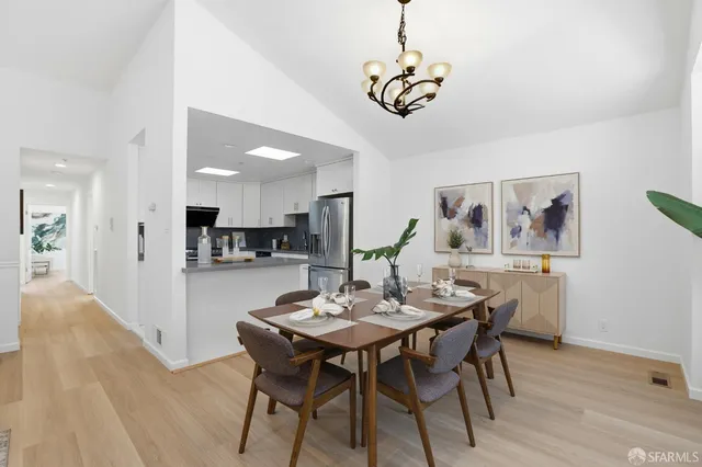 a view of a dining room with furniture wooden floor and a chandelier