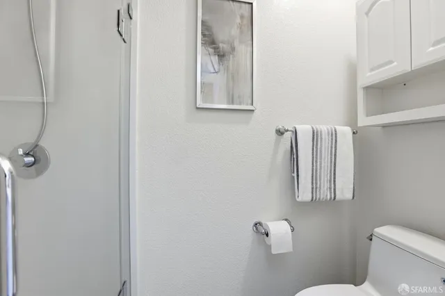 a white toilet sitting next to a bathroom sink