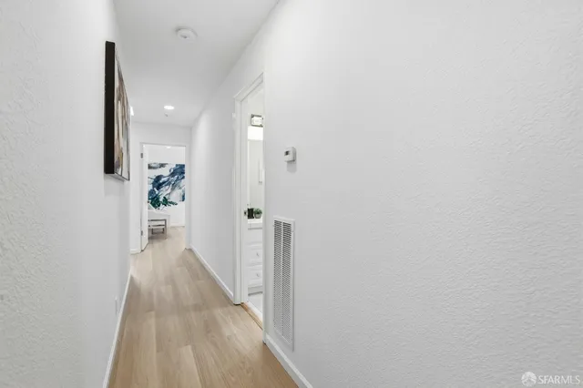 a view of a hallway with wooden floor