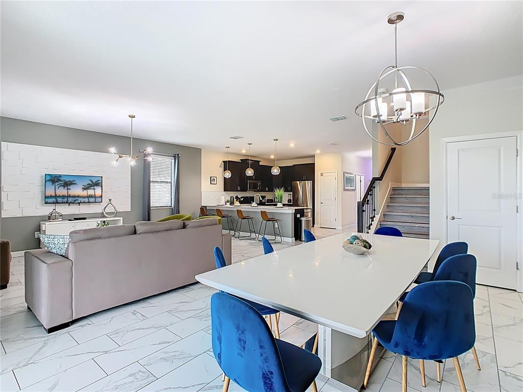 2925 Fable Street Kissimmee, FL 34746 - Photo 15 of 56 a view of a dining room with furniture and a chandelier