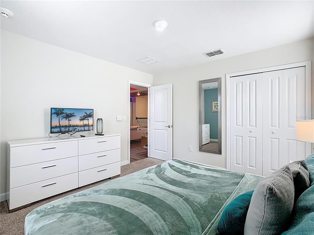 2925 Fable Street Kissimmee, FL 34746 - Photo 22 of 56 a bedroom with a bed and a dresser