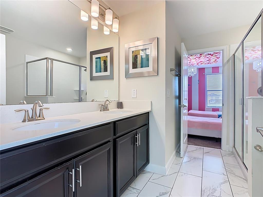 2925 Fable Street Kissimmee, FL 34746 - Photo 27 of 56 a bathroom with a sink a vanity and a mirror