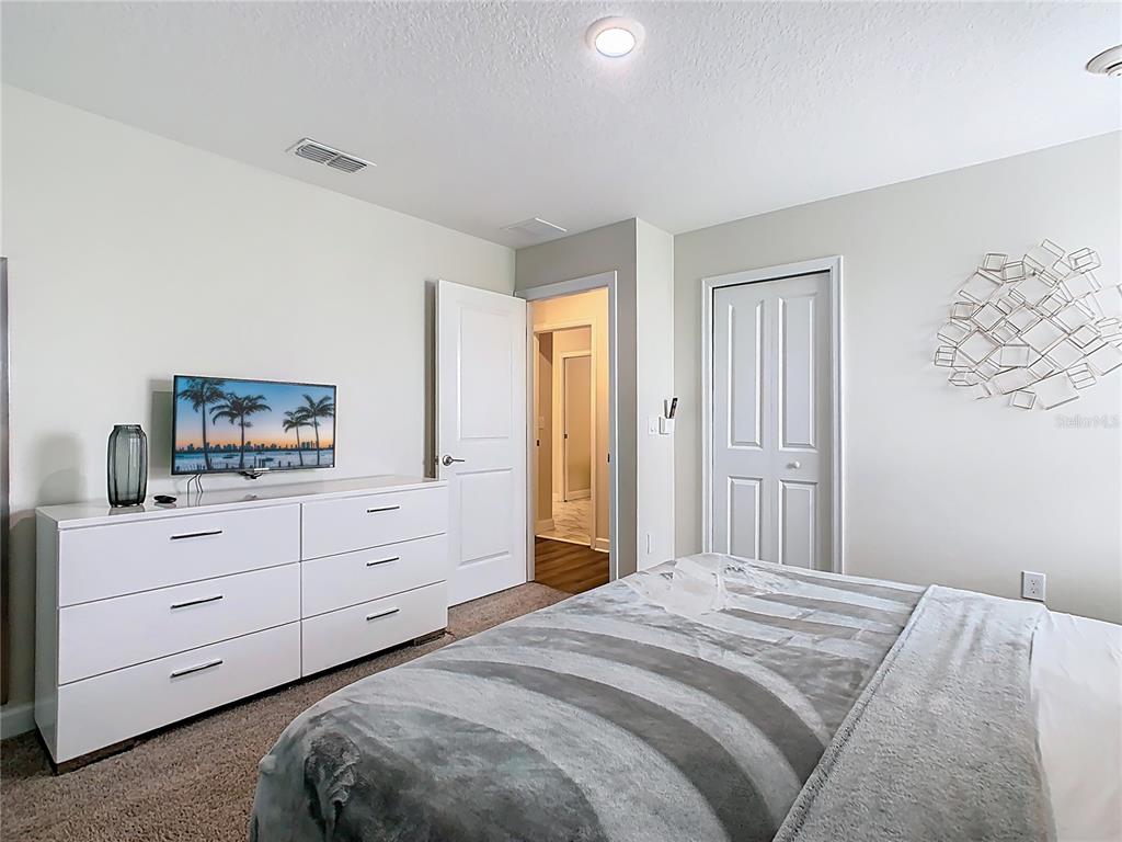 2925 Fable Street Kissimmee, FL 34746 - Photo 35 of 56 a bedroom with a bed and a dresser