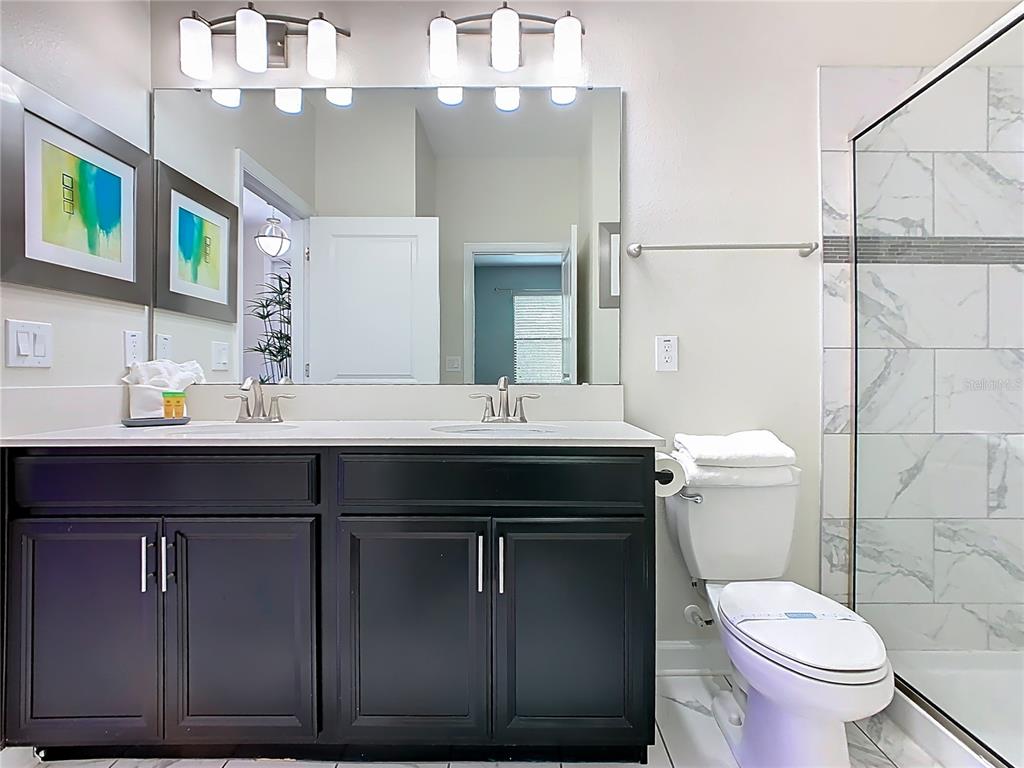 2925 Fable Street Kissimmee, FL 34746 - Photo 38 of 56 a bathroom with a sink vanity mirror and toilet