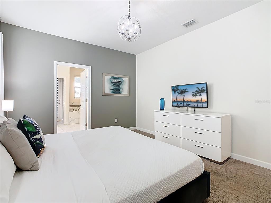 2925 Fable Street Kissimmee, FL 34746 - Photo 39 of 56 a bedroom with a bed and a dresser