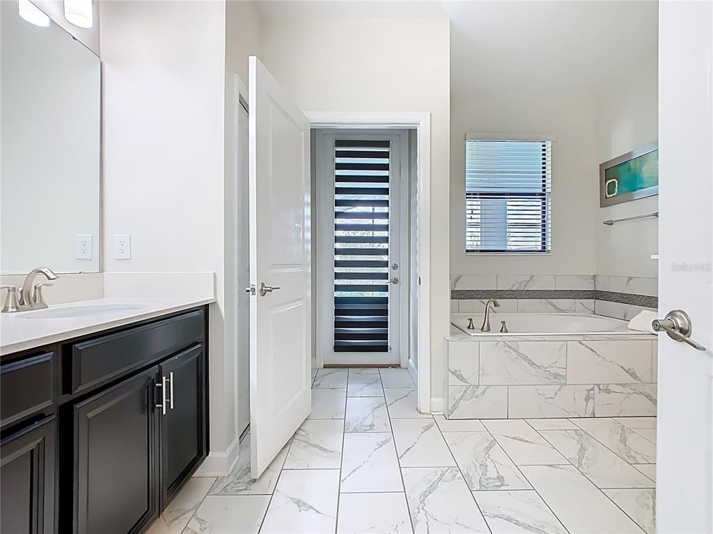 2925 Fable Street Kissimmee, FL 34746 - Photo 42 of 56 a bathroom with a sink and a mirror