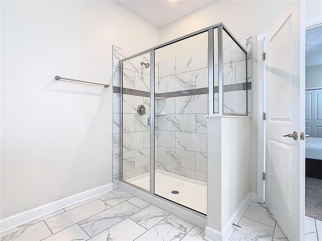 2925 Fable Street Kissimmee, FL 34746 - Photo 44 of 56 a bathroom that has a glass shower door