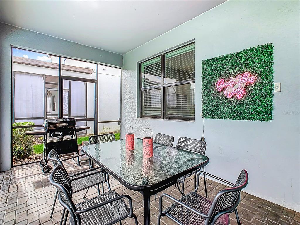 2925 Fable Street Kissimmee, FL 34746 - Photo 52 of 56 a living room with furniture and a floor to ceiling window
