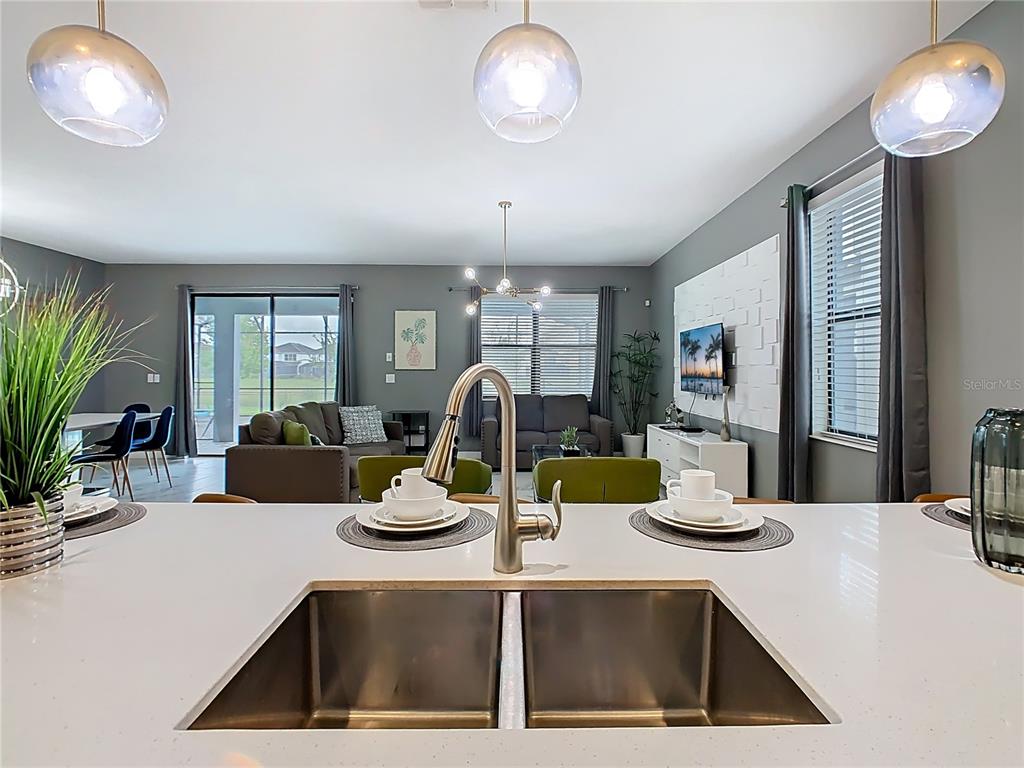 2925 Fable Street Kissimmee, FL 34746 - Photo 10 of 56 a kitchen with a refrigerator a stove and cabinets