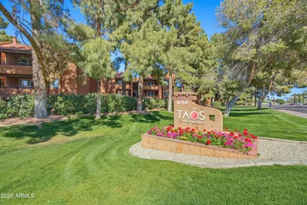 a view of a house with fountain and garden