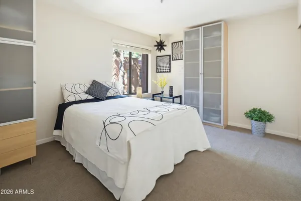 a bed sitting in a bedroom next to a window
