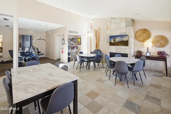 a living room with pool table and windows