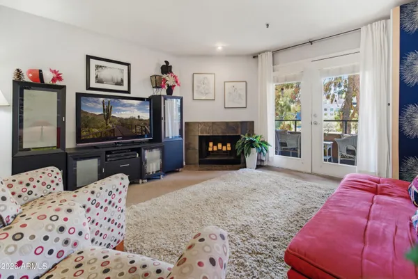 a kitchen with stainless steel appliances granite countertop a dining table chairs refrigerator and sink