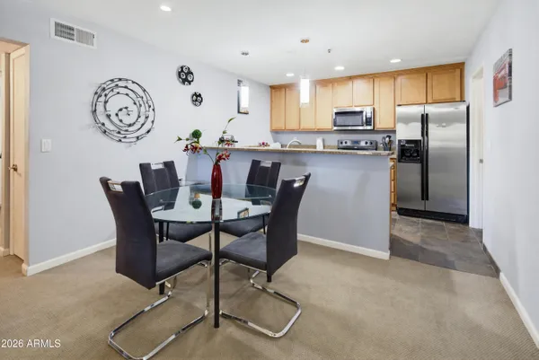 a kitchen with stainless steel appliances granite countertop a refrigerator a stove top oven a sink and dishwasher