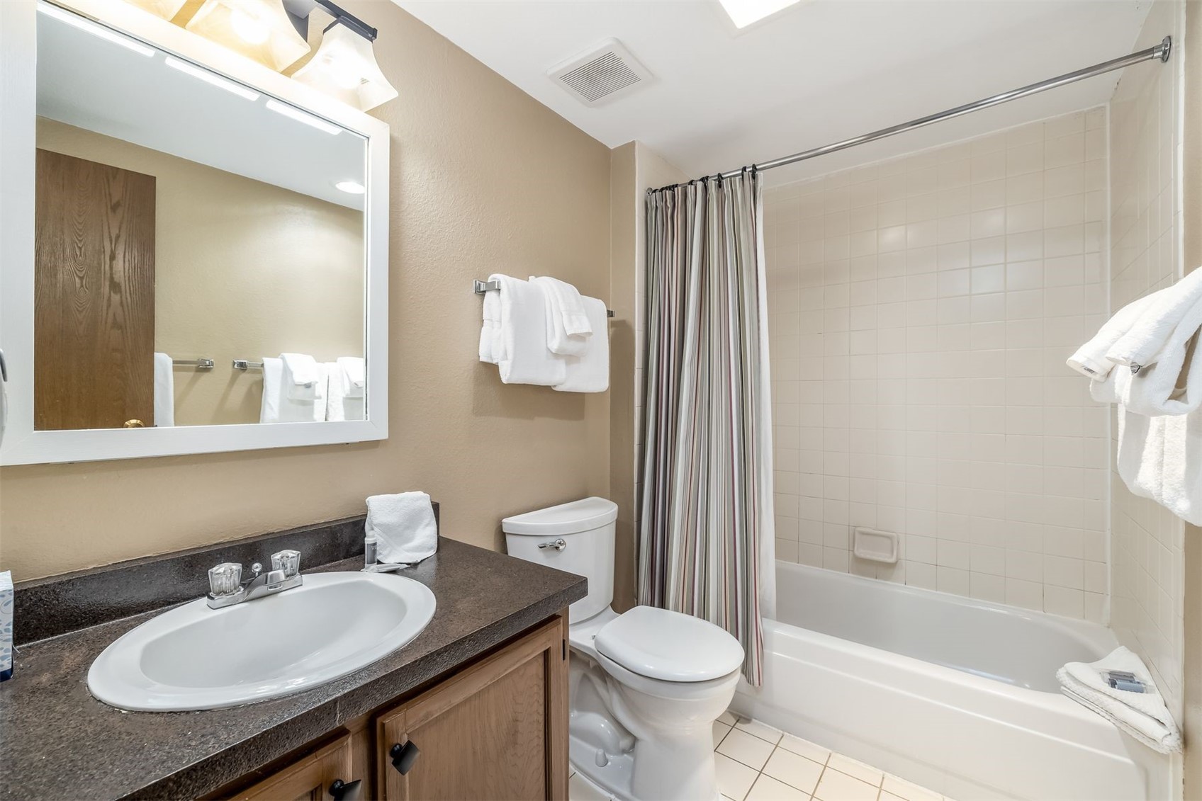1977 Soda Ridge Road, Unit 1194 Keystone, CO 80435 - Photo 23 of 38 a bathroom with a sink toilet a mirror and shower
