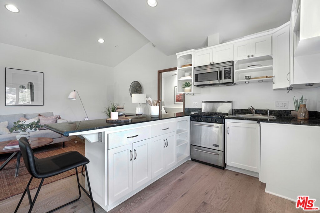 458 Rustic Drive Los Angeles, CA 90065 - Photo 25 of 41 a kitchen with stainless steel appliances white cabinets and sink