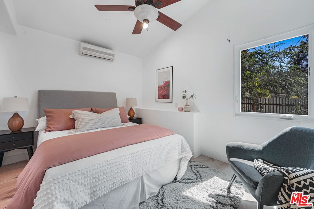 458 Rustic Drive Los Angeles, CA 90065 - Photo 26 of 41 a bedroom with a bed and wooden floor