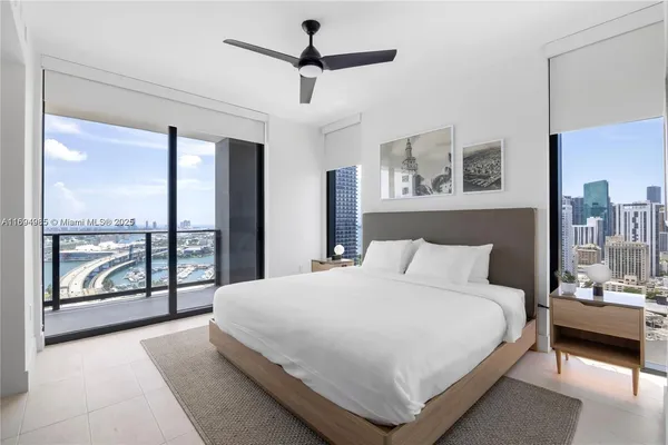 a bedroom with a large bed and a large window