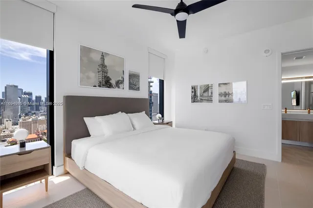 a bedroom with a large bed and a chandelier