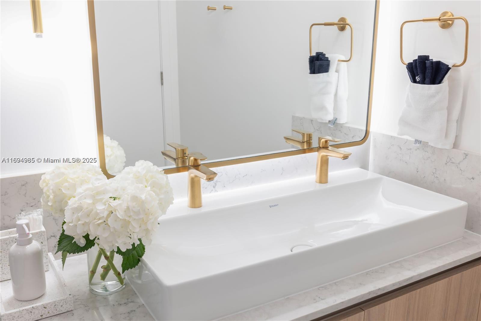 159 Northeast 6th Street, Unit 2916 Miami, FL 33132 - Photo 19 of 44 a bathroom with a sink and a mirror