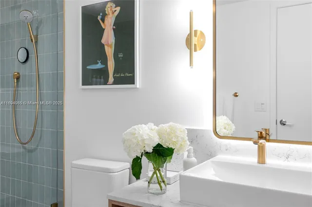 a bathroom with a sink mirror and vanity