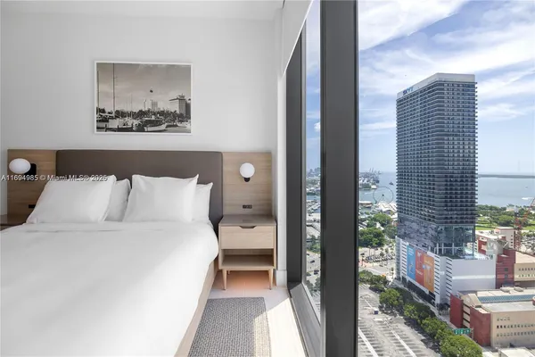 a bed room with a bed and a painting