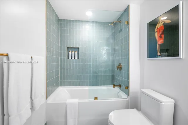 a bathroom with a toilet a sink and bathtub