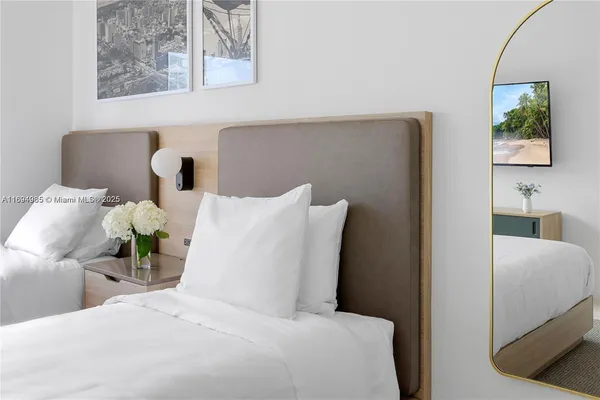 a bedroom with a bed and a painting on the wall