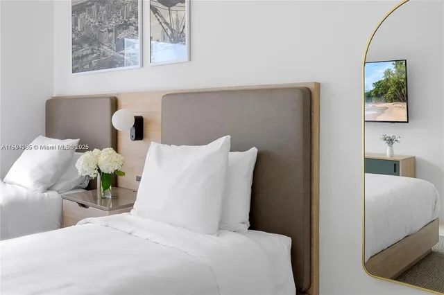 a bedroom with a bed and a painting on the wall