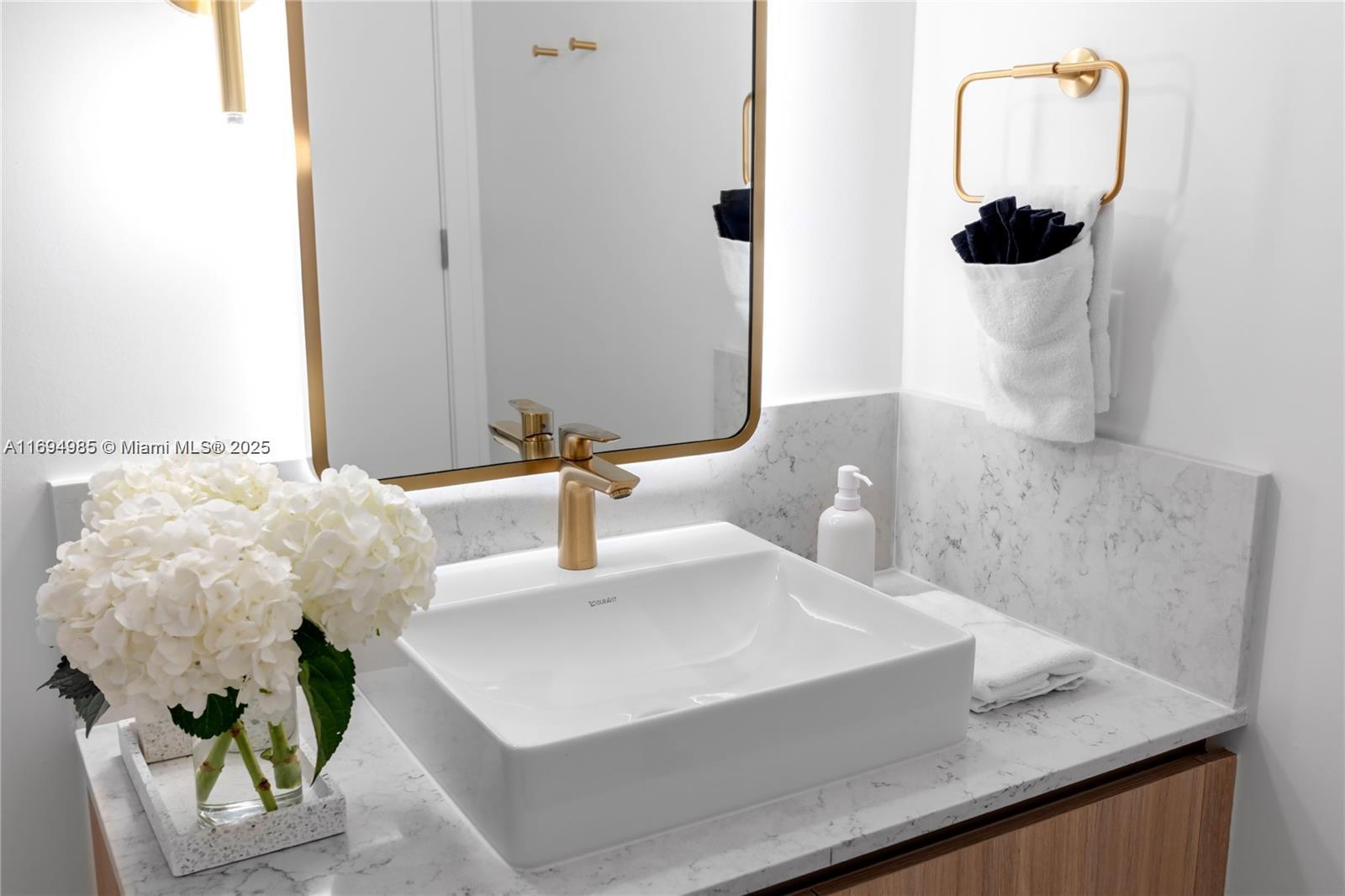 159 Northeast 6th Street, Unit 2916 Miami, FL 33132 - Photo 31 of 44 a bathroom with a sink and a mirror