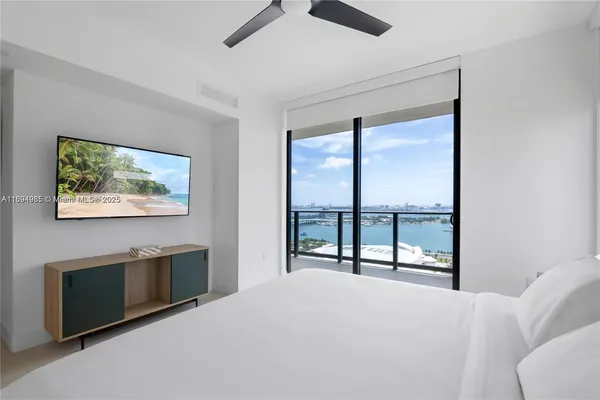 a bedroom with a bed and a painting on the wall