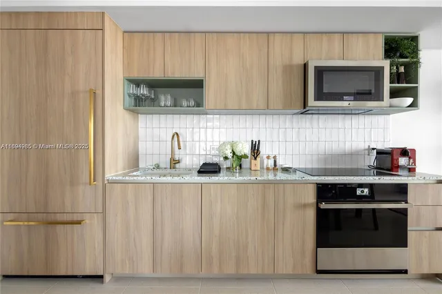 a kitchen with stainless steel appliances a sink a stove and microwave