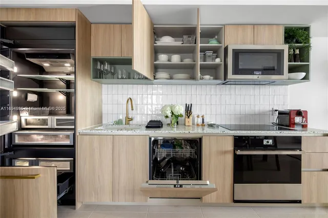 a kitchen with stainless steel appliances a stove and a microwave