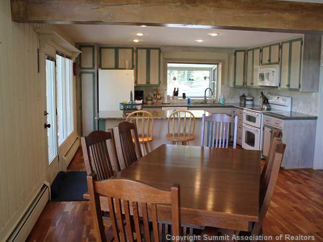 576 Moonstone Road Breckenridge, CO 80424 - Photo 13 of 22 a view of a dining room with furniture window and wooden floor
