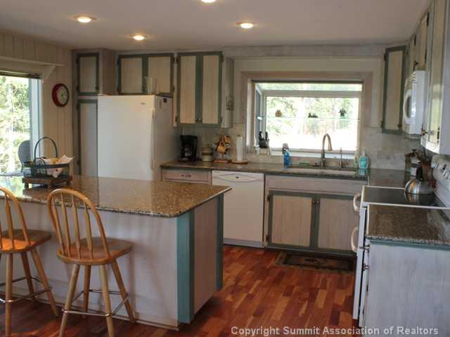 576 Moonstone Road Breckenridge, CO 80424 - Photo 14 of 22 a kitchen with granite countertop a sink stove and refrigerator